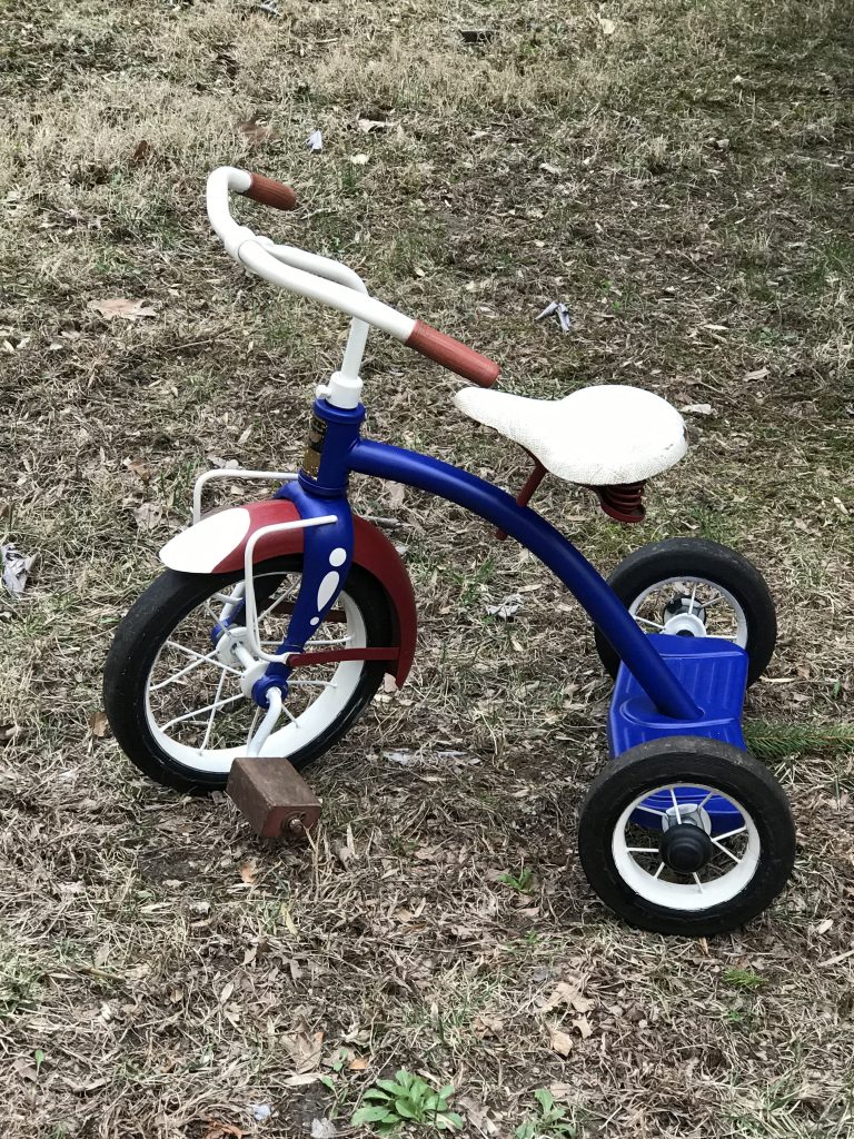 vintage red white and blue tricycle after